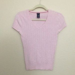 Baby pink sweater-like top.